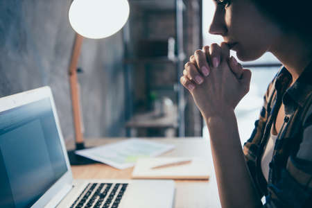 Cropped close-up profile side view of nice attractive manager director serious brunette lady in checked shirt reading online book review report at industrial loft style interior work place stationの写真素材