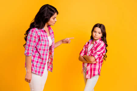 You should parenthood concept profile side view photo beautiful disappointed mom depressed kid have disagreement stress offense point index finger dressed checked shirt isolated yellow backgroundの写真素材