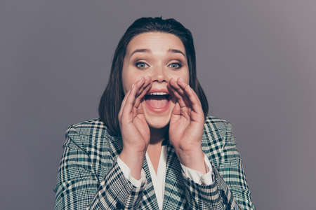 Closeup photo image portrait of noisy pretty beautiful she her office employer holding hands cupped near opened mouth isolated grey backgroundの写真素材