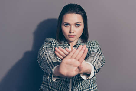 Close up photo studio portrait of serious confident making giving refusal gesture to you camera with two hands isolated grey backgroundの写真素材