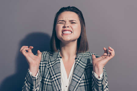 Close up photo portrait of unhappy sad upset grimacing screaming shouting gesturing fingers trying to scratch you unsatisfied boss isolated grey backgroundの写真素材
