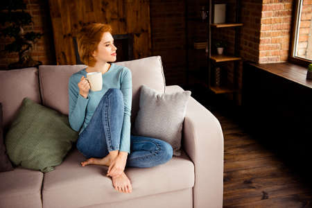 Close up photo beautiful she her lady hands arms hot favorite beverage stay home lazy peaceful mood look window wear blue casual pullover jeans denim sit comfy divan house living room indoorsの写真素材