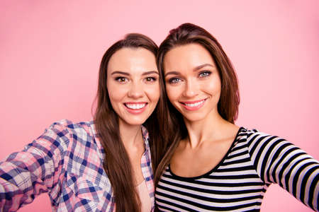 Self-portrait of nice-looking attractive lovely sweet fascinating winsome magnificent cute charming cheerful cheery straight-haired girls isolated over pink pastel backgroundの写真素材