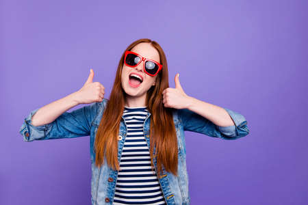 Portrait of her she nice-looking attractive charming cute lovely cheerful funny glad excited straight-haired lady showing thumbup isolated over bright vivid shine violet backgroundの写真素材