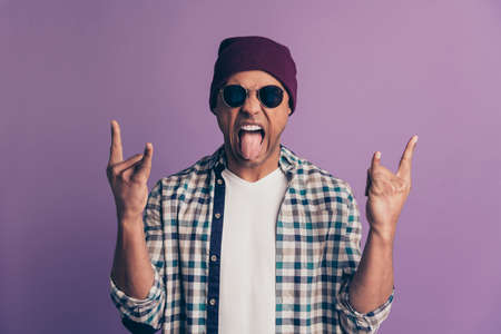 Close up photo amazing beautiful funky guy macho white perfect teeth stylish look show v-sign hands arms wear casual plum color headwear checkered plaid shirt isolated purple violet backgroundの写真素材