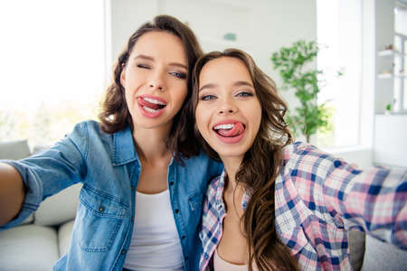 Close up photo beautiful cute ladies buddies meeting gathering make take selfies tongue out mouth...