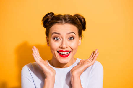 Close-up portrait of her she nice-looking attractive winsome optimistic cheerful cheery funny glam teen girl clapping palms isolated over bright vivid shine yellow backgroundの写真素材