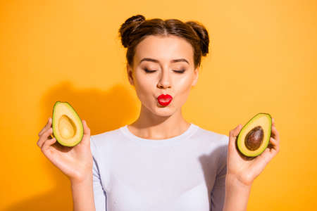 Close up photo beautiful she her lady pretty hairdo send air kisses romantic hold two half slices...