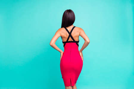 Close up back rear behind photo beautiful she her lady not show face tender figure forms perfect skinny body hold arms hands ideal booty formal-wear red dress isolated teal turquoise bright backgroundの写真素材