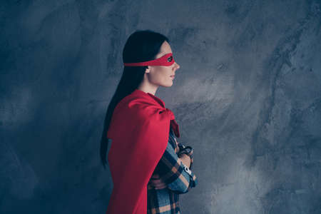 Profile side view portrait of her she nice-looking lovely charming attractive confident calm lady wearing hero look outfit folded arms isolated over grey concrete wallの写真素材