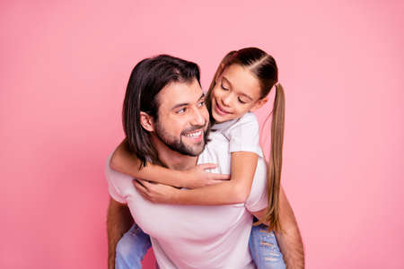 Close up photo beautiful adorable she her little lady he him his daddy dad hold little princess piggyback hands arms funny funky wear casual white t-shirts denim jeans isolated pink bright backgroundの写真素材