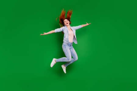Full length body size view portrait of her she nice-looking attractive lovely cheerful cheery girl having fun freedom isolated over bright vivid shine green backgroundの写真素材