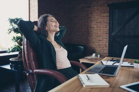 Portrait of content pretty lady freelancer chief sit in big comfort armchair place hand s behind...