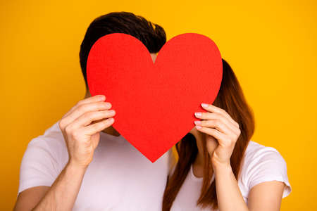 Close up photo beautiful she her he him his guy lady hiding kissing faces hold hands arms big heart...