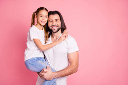 Close up photo beautiful she her little lady he him his daddy hold little princess hands arms affection sweet relax look eyes wear casual white t-shirts denim jeans isolated pink bright backgroundの写真素材