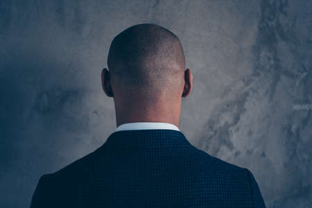Back rear behind closeup view photo portrait of thoughtful handsome guy looking back isolated grey...