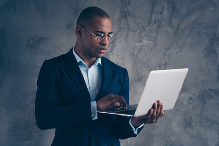 Close up photo ceo user apps freelancer concepts use modern technology trendy chief think thoughtful read news solve gorgeous gentleman chief modern jacket short hair bald isolated dark background.の写真素材