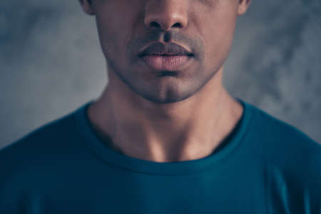 Cropped close-up portrait of his he nice lovely attractive good-looking candid well-groomed guy wearing blue t-shirt isolated over gray industrial concrete wall.の写真素材