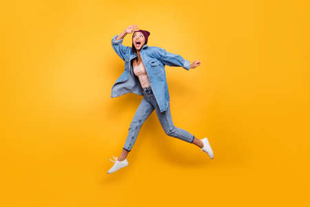 Full length body size view photo funny funky youngster person fool spring summer enjoy rejoice amazed surprised joke scream shout speed hurry motion wear trendy clothes cap isolated vivid backgroundの写真素材