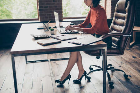 Cropped profile side view of nice attractive serious top director bookkeeper ceo boss chief employee wearing casual formal-wear in modern loft wooden industrial style interior work place stationの写真素材