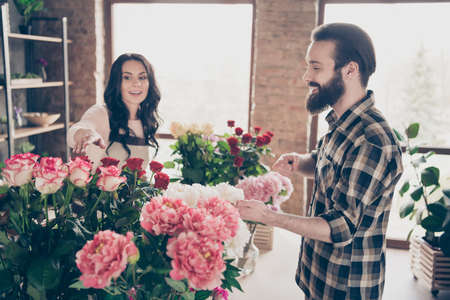 Close up side profile photo beautiful she her lady asking advising buy him his he macho guy best composition handmade bunch fresh flowers holiday valentine day 8 march small flower shop room indoorsの写真素材