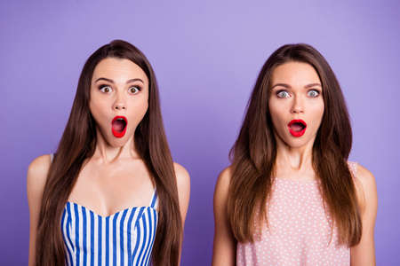 Close-up portrait of nice-looking charming cute lovely glamorous attractive amazed crazy ladies sale discount opened mouths stare eyes isolated over pastel violet backgroundの写真素材