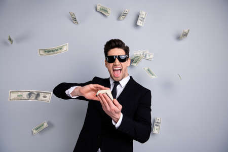 Portrait of his he nice attractive cheerful guy professional executive leader expert development agent broker financier banker throwing away exchange lottery credit isolated over light gray backgroundの写真素材