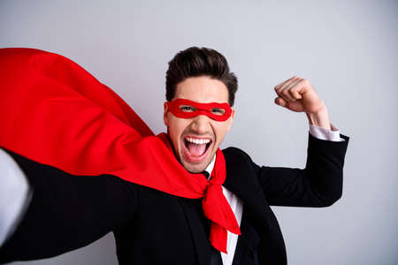 Close up photo adventurous expression  man flying use superpower make take selfies show strong hand arm wear red cloak raised wind protection human comics character isolated grey backgroundの写真素材