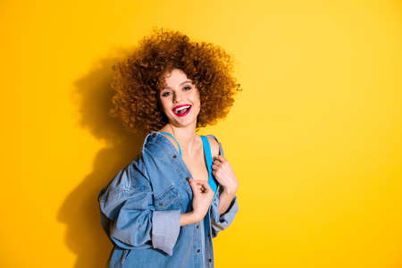 Portrait of her she nice-looking charming attractive cheerful cheery positive glamorous girl isolated over bright vivid shine yellow backgroundの写真素材