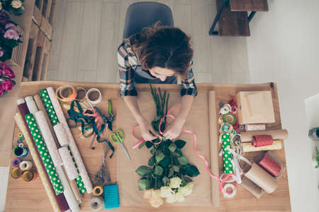 Top above high angle view photo skilled busy focused lady assistant orangery surprise 8-march 14-february botanical wavy curly haircut nature floral craft art trendy stylish shirt indoors workplaceの写真素材