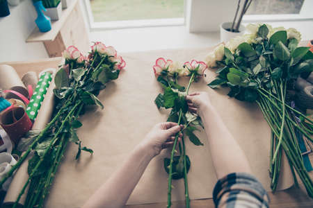 Close up top above high angle first person view photo beautiful process creating bow birthday 8 march valentine day bunch gift present seller fresh flowers owner small flower shop room indoorsの写真素材