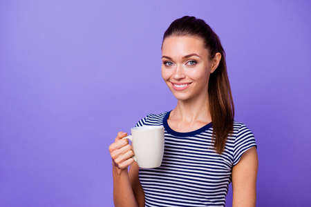Portrait charming nice lady millennial striped t-shirt hold hand beverage hot smell feel confident cool independent content friendly fashionable expensive clothing isolated bright violet backgroundの写真素材