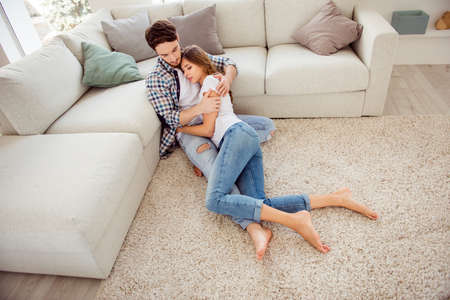 Portrait of his he her she nice-looking attractive lovely charming slim fit thin calm peaceful morning sitting lying on cosy floor in light white style interior living room hotel house indoorsの写真素材