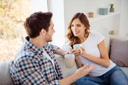 Nice-looking attractive lovely charming cute sweet cheerful guy lady sitting on couch sofa having...