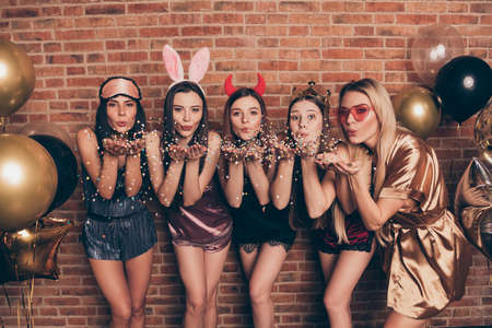 Portrait of nice company attractive sweet lovely gorgeous funny flirty cheerful positive ladies eyewear sending you kiss blowing glow glossy isolated over industrial brick wallの写真素材