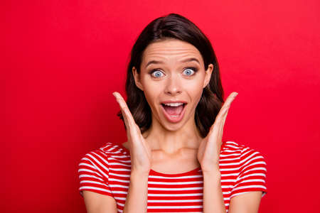 Portrait of pretty lovely sweet lady youth astonished shout incredible sales black friday impressed wonder thrilled isolated red backgroundの写真素材