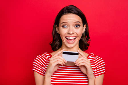 Portrait of funny funky teen teenager hold hand have credit card want bargain astonished impressed...