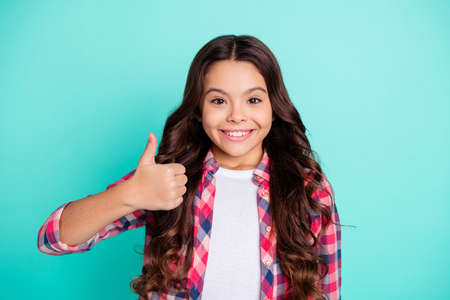 Portrait of attractive pretty child future promoter promotion adverts advertise decide choose suggest excellent discount wear modern youth outfit isolated teal background.の写真素材