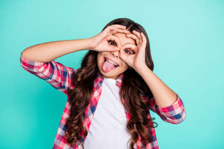 Portrait cute charming attractive beautiful trendy girl free time rest relax fool weekend holidays summer make faces positive childish playful shirt checked shirt clothes isolated green background.の写真素材