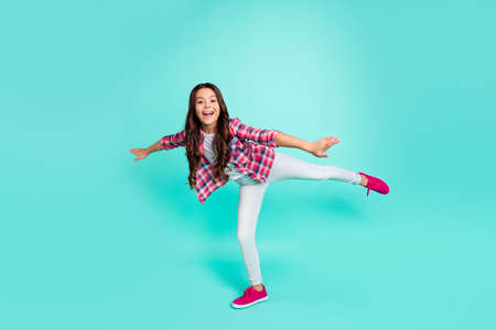 Full length body size view of charming nice pretty girl enjoy trip relax rest do sport move movement glad scream travel trip childish dressed plaid outfit isolated green background.の写真素材