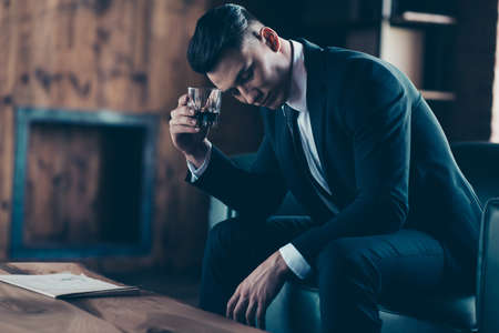 Close up side profile photo handsome he him his pensive ponder hands arms whisky beverage eyes...