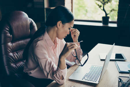 Profile side view portrait of her she nice attractive bored busy lady top specialist ceo boss chief difficult day suffering from pain at modern industrial loft interior style work place stationの写真素材