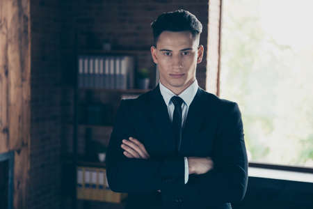 Close up photo perfect look handsome he him his thoughtful hands arms crossed moody chief attentive look self-confident wear formal-wear shirt jacket tie suit costume indoors modern office placeの写真素材