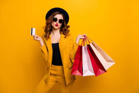 Close up photo beautiful she her lady hands arms credit plastic card many packs buyer vacation traveler sale discount rich person wear specs formal-wear suit isolated yellow bright backgroundの写真素材