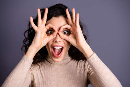 Close up photo attractive amazing she her lady okey symbol near eyes specs form figure white teeth watch novelty buy buyer shopping black friday wear casual pastel pullover isolated grey backgroundの写真素材