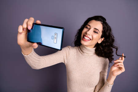 Close up photo attractive funny she her lady hold hands arms telephone make take selfiesの写真素材