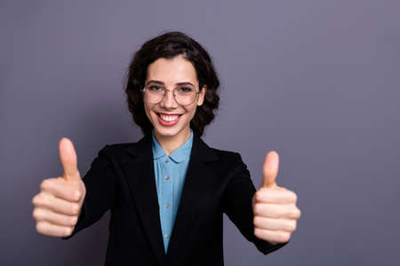 Portrait of charming gorgeous entrepreneur agree excellent choice advertise real promoter dressed black blazer jacket wavy curly hairstyle hairdo isolated grey backgroundの写真素材