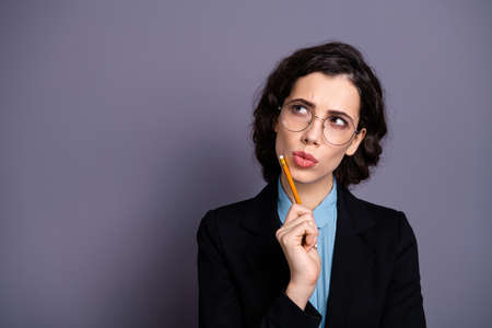 Close up photo of nice charming pensive lady have thought choice decision decide solution start-up document clever millennial wavy curly hairstyle isolated grey backgroundの写真素材