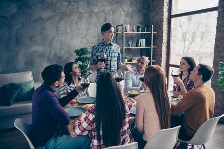 Close up photo amazing company event eight members best fellows buddies guests ladies guys wineglasses beverage say tell toasting shirts formal-wear sweaters pullovers hanging out loft room indoorsの写真素材