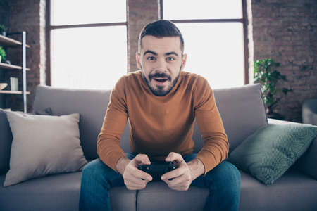 Portrait of guy spending weekend playing game console